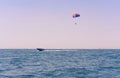 Sea view of a man Parasailing in the water towed by a speedboat in American flag colours