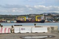 Sea view of Marseille`s industrial harbour with cargo cranes and ships and its Hollywood inscription in the South of France