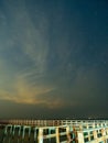 Sea view near mangrove forest with man made wooden barrier for wave protection, under starry nigh cloudy sky Royalty Free Stock Photo