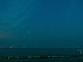 Sea view near mangrove forest with man made wooden barrier for wave protection, under starry nigh cloudy sky Royalty Free Stock Photo