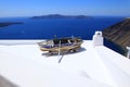 Sea view and an old boat on a roof on Santorini