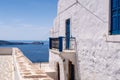 Sea view from Plaka Town on Milos Island, Greece, with whitewashed traditional house with blue window shutters