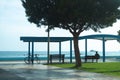 Sea view and unrecognizable man sitting on the beach near a pier and looking on the sea Royalty Free Stock Photo