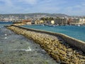 The sea wall in Chania harbour, Crete leading towards refurbished boat houses Royalty Free Stock Photo