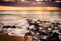 Sea washing up on the beach over some rocks with motion blur of the water. Long exposure. Ocean landscape during sunset. Dreamland Royalty Free Stock Photo