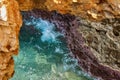 Sea water breaks on the rocks inside the grotto Royalty Free Stock Photo