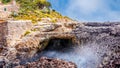 Sea water erupting from cave on the cost of Cala sAlmunia, Mallorca, Spain