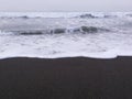 Sea water that followed beautiful waves in the beach. black sand beach.