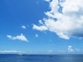 Sea water landscape with blue sky and ripples. Seashore view with white boats. Royalty Free Stock Photo