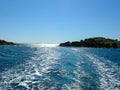 Sea water ship trail with white foamy wave. Tropical islands ferry travel. Bubble tail after cruise ship. Deep ocean view. Royalty Free Stock Photo