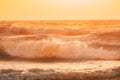 Sea water surface at sunset. Natural sunrise warm colors of ocean. Sea ocean water surface with foaming small waves at Royalty Free Stock Photo