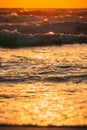 Sea water surface at sunset. Natural sunset warm colors of ocean. Sea ocean water surface with foaming small waves at Royalty Free Stock Photo