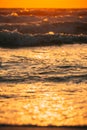Sea water surface at sunset. Natural sunset warm colors of ocean. Sea ocean water surface with foaming small waves at Royalty Free Stock Photo