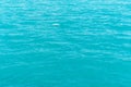 Sea water texture background with a small wave. Ocean surface aerial view. Shining azure water ripple background. Summer concept