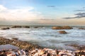 Sea water and wave with stones and sunlight cloud blue sky after sunrise in the morning at coast in Hua-hin southern of Thailand Royalty Free Stock Photo