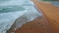 Sea water waves foaming sand close up. Stormy ocean surf washing seashell beach