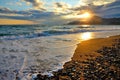 Sea wave on the beach, the surf on the Black sea coast at sunset.