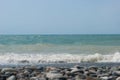 The Sea Wave of the Black Sea is a pebble beach. Smooth horizon, blue sky.