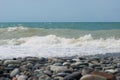 The Sea Wave of the Black Sea is a pebble beach. Smooth horizon, blue sky.