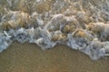 Sea wave breaking into the sand