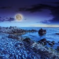 Sea wave breaks about boulders at night Royalty Free Stock Photo