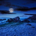 Sea wave breaks about boulders at night Royalty Free Stock Photo