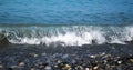 Sea wave breaks on the shore with pebbles Royalty Free Stock Photo