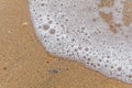 Sea wave bubble with sandy shore