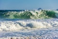 Sea wave crashing on the beach on a sunny day in summer Royalty Free Stock Photo