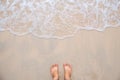 Sea wave movement with feet and sand.