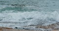 Sea wave over rock stone at sea shoreline