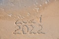 Sea wave rolling onto sandy beach with written 2021 and 2022. New Year Royalty Free Stock Photo