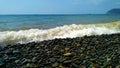 Sea wave rolls onto a large-pebble beach Royalty Free Stock Photo