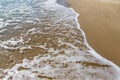 Sea wave runs on wet sand. Natural background Royalty Free Stock Photo