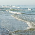 Sea wave on a sandy beach. Sea view from tropical beach with sunny sky. Seashore, beach, waves on the sea