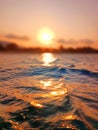 Sea wave splash, sunset, ocean water surf, sunrise, tropical island beach dawn, sun reflection, summer holidays, vacation Royalty Free Stock Photo