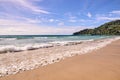 Sea waves. Blue sky. Bright sand. Green trees Royalty Free Stock Photo