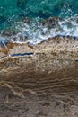 Sea waves breaking on rocky shore, aerial vertical shot