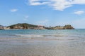 Sea waves crash against the shore against the backdrop of a Mediterranean landscape