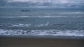 Sea waves crash beach on dark stormy weather ocean coast landscape background. Royalty Free Stock Photo