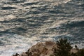 Sea waves crashing against the rocks of mediterranean shore during sunset Royalty Free Stock Photo