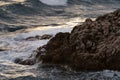 Sea waves crashing against the rocks of mediterranean shore during sunset Royalty Free Stock Photo