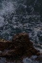 Sea waves crashing against the rocks of mediterranean shore during sunset Royalty Free Stock Photo