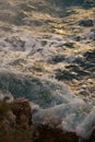 Sea waves crashing against the rocks of mediterranean shore during sunset Royalty Free Stock Photo