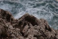 Sea waves crashing against the rocks of mediterranean shore during sunset Royalty Free Stock Photo