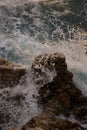 Sea waves crashing against the rocks of mediterranean shore during sunset Royalty Free Stock Photo