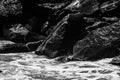 sea waves with foam and large stones. black and white beach photography Royalty Free Stock Photo