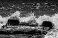 sea waves with foam and large stones. black and white beach photography Royalty Free Stock Photo