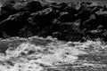 sea waves with foam and large stones. black and white beach photography Royalty Free Stock Photo