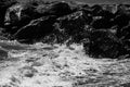 sea waves with foam and large stones. black and white beach photography Royalty Free Stock Photo